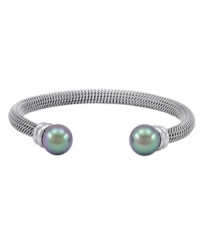 Intriguingly iridescent. Black organic made-made pearls add distinguished decorative detailing to Majorica's bangle bracelet. Set in silver tone stainless steel, it's an elegant enhancement for daytime or evening. Approximate diameter: 2-1/2 inches. Intriguingly iridescent. Black organic made-made pearls add distinguished decorative detailing to Majorica's bangle bracelet. Set in silver tone stainless steel, it's an elegant enhancement for daytime or evening. Approximate diameter: 2-1/2 inches.
