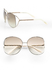A chic metal style with intricately detailed temples and modern floating lens. Available in rose gold/ivory with brown gradient lens. Logo etched lens100% UV protectionMade in Italy A chic metal style with intricately detailed temples and modern floating lens. Available in rose gold/ivory with brown gradient lens. Logo etched lens100% UV protectionMade in Italy