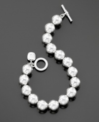 A silvertone ball bracelet (10 mm) from Lauren Ralph Lauren with a pretty logo charm and trendy toggle closure. Length measures 7-1/2 inches. A silvertone ball bracelet (10 mm) from Lauren Ralph Lauren with a pretty logo charm and trendy toggle closure. Length measures 7-1/2 inches.