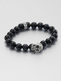 A striking skull pendant of sterling silver accents a stretch beaded bracelet of blue tigers' eye for the modern man of style.Sterling silverTigers' eyeWidth, about 10mmDiameter, about 3Made in USA