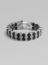 Architectural drama defines this bold bracelet, constructed of double rows of black onyx beads held by scalloped pillars of sterling silver. Black onyx Sterling silver Length, about 8¾ Lobster clasp Imported Architectural drama defines this bold bracelet, constructed of double rows of black onyx beads held by scalloped pillars of sterling silver. Black onyx Sterling silver Length, about 8¾ Lobster clasp Imported