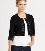 Glimmering sequins lend a glam touch to this boxy knit bolero.Round necklineLong sleevesOpen frontAbout 15 from shoulder to hem80% rayon/20% nylonDry cleanImported