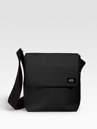 A sturdy, compact bag designed in nylon canvas for strength and durability. The body material is 1100 denier canvas, producing the greatest density between yarns and ensuring water resistance. Structured yet pliable, it is a sturdy fabric that eases with use. Flap/grip-tape closure Adjustable shoulder strap Padded computer slip pocket Exterior, interior organizing pockets Nylon canvas 9½W X 11¼H X 3½D Imported A sturdy, compact bag designed in nylon canvas for strength and durability. The body material is 1100 denier canvas, producing the greatest density between yarns and ensuring water resistance. Structured yet pliable, it is a sturdy fabric that eases with use. Flap/grip-tape closure Adjustable shoulder strap Padded computer slip pocket Exterior, interior organizing pockets Nylon canvas 9½W X 11¼H X 3½D Imported