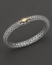 Bright splashes of 18K yellow gold bring sunny, exotic style to this intricately woven sterling silver bracelet. Bright splashes of 18K yellow gold bring sunny, exotic style to this intricately woven sterling silver bracelet.
