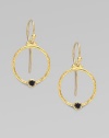 From the Clover Collection. A simple, delicate hoop of 24K gold with a single black diamond accent.Black diamond, 0.24 tcw 24K yellow gold Width, about ¾ Length, about 1 Ear hooks Imported 