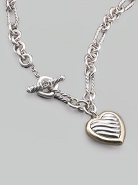 A striking chain, combining oval and circle links, both smooth and textured, holds a pretty cable heart charm framed in 18k yellow gold. Sterling silver and 18k yellow gold Chain length, about 16 Pendant length, about ¾ Toggle closure Made in USA A striking chain, combining oval and circle links, both smooth and textured, holds a pretty cable heart charm framed in 18k yellow gold. Sterling silver and 18k yellow gold Chain length, about 16 Pendant length, about ¾ Toggle closure Made in USA