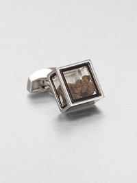 Inspired by the tale of Pandora's box in Greek mythology and featuring the Tateossian signature element of surprise, this glass-box cuff link holds pieces of genuine dinosaur bone. The Dinosaur Bone consists of a collection of Edmontosaurus Annectens bone pieces from a femur that dates back to the late Cretaceous Period about 65.5 millionyears ago. Inspired by the tale of Pandora's box in Greek mythology and featuring the Tateossian signature element of surprise, this glass-box cuff link holds pieces of genuine dinosaur bone. The Dinosaur Bone consists of a collection of Edmontosaurus Annectens bone pieces from a femur that dates back to the late Cretaceous Period about 65.5 millionyears ago.