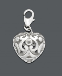 Add a drop of silver sophistication to any necklace or bracelet. This intricate scrolling heart charm features cubic zirconia accents. Set in sterling silver. Approximate drop: 1/2 inch. Add a drop of silver sophistication to any necklace or bracelet. This intricate scrolling heart charm features cubic zirconia accents. Set in sterling silver. Approximate drop: 1/2 inch.
