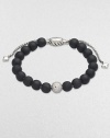 Rich black onyx, accented by a brilliant pavé diamond ball, is fastened by an adjustable clasp of textured sterling silver.Diamonds, 0.87 tcw Black onyx Sterling silver Bead diameter, about ¾ Imported