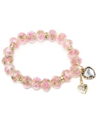 Floral and fanciful. With its beautiful pink blooms, Betsey Johnson's beaded stretch bracelet lends a touch of springtime to your look all year long. Adorned with sparkling crystals, it's crafted in gold tone mixed metal. Bracelet stretches to fit wrist. Approximate length: 7-1/2 inches.