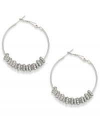 Put on the charm. Bar III's hoop earrings embrace crystal shimmer with charm accents. Crafted in silver tone mixed metal. Approximate diameter: 1-1/2 inches. Put on the charm. Bar III's hoop earrings embrace crystal shimmer with charm accents. Crafted in silver tone mixed metal. Approximate diameter: 1-1/2 inches.