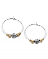 Petite hoops pop with the addition of gold tone brass and silver beads. Set in sterling silver. Approximate diameter: 3/4 inch. Petite hoops pop with the addition of gold tone brass and silver beads. Set in sterling silver. Approximate diameter: 3/4 inch.