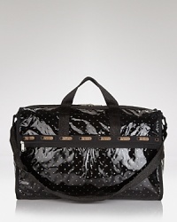 LeSportsac gives its signature, super spacious travel bag a jet set makeover with a glossy coating and gleaming trims. LeSportsac gives its signature, super spacious travel bag a jet set makeover with a glossy coating and gleaming trims.