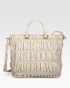 Ruched nappa leather in a top handle silhouette with logo detail.Double top handles, 5 dropAdjustable, detachable shoulder strap, 19-20 dropTop snap closureProtective metal feetTwo inside zip pocketsThree inside open pocketsPrada logo lining15W X 13H X 6½DMade in Italy