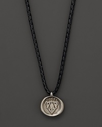 Silver Gucci charm on a braided black natural leather necklace. Silver Gucci charm on a braided black natural leather necklace.
