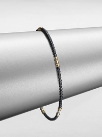 A simple chic piece that features faceted beads in blackened sterling silver accented with five, 14k gold beaded sections. Blackened sterling silver14k goldDiameter, about 2.5Slip-on styleMade in USA A simple chic piece that features faceted beads in blackened sterling silver accented with five, 14k gold beaded sections. Blackened sterling silver14k goldDiameter, about 2.5Slip-on styleMade in USA