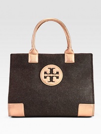 Warm and tactile felt accented in contrasting, metallic leather trim.Double leather top handles, 7½ dropMagnetic snap closureOne inside zip pocketTwo inside open pocketsCotton lining17W X 13H X 5¾DImported Warm and tactile felt accented in contrasting, metallic leather trim.Double leather top handles, 7½ dropMagnetic snap closureOne inside zip pocketTwo inside open pocketsCotton lining17W X 13H X 5¾DImported
