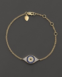 The traditional evil eye charm is lavishly updated with sparkling diamonds and blue, white and yellow sapphires. The traditional evil eye charm is lavishly updated with sparkling diamonds and blue, white and yellow sapphires.