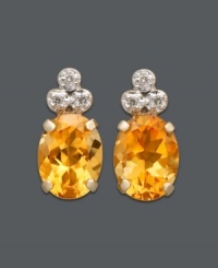 Add a ray of sunshine to your look. These sunny studs feature oval-cut citrine (1-9/10 ct. t.w.) topped with three, sparkling diamond accents. Set in 14k gold. Approximate diameter: 1/2 inch. Add a ray of sunshine to your look. These sunny studs feature oval-cut citrine (1-9/10 ct. t.w.) topped with three, sparkling diamond accents. Set in 14k gold. Approximate diameter: 1/2 inch.