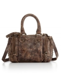 This classic satchel silhouette by Frye gets a western-inspired makeover. A distressed exterior with signature hardware and side zip pockets gives this style a rugged yet refined appeal. This classic satchel silhouette by Frye gets a western-inspired makeover. A distressed exterior with signature hardware and side zip pockets gives this style a rugged yet refined appeal.
