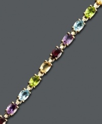 Spice up your look with a myriad of colors. Victoria Townsend's playful bracelet style highlights oval-cut garnet (4 ct. t.w.), amethyst (2-1/2 ct. t.w.), citrine (3-1/4 ct. t.w.), peridot (2-3/4 ct. t.w.), and blue topaz (3-1/4 ct. t.w.). Crafted in 18k gold over sterling silver. Approximate length: 7 inches. Spice up your look with a myriad of colors. Victoria Townsend's playful bracelet style highlights oval-cut garnet (4 ct. t.w.), amethyst (2-1/2 ct. t.w.), citrine (3-1/4 ct. t.w.), peridot (2-3/4 ct. t.w.), and blue topaz (3-1/4 ct. t.w.). Crafted in 18k gold over sterling silver. Approximate length: 7 inches.