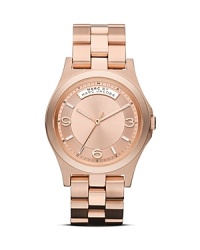 A cool logo plaque details this MARC BY MARC JACOBS watch, which is classically styled in plated metal and set on a matching bracelet. A cool logo plaque details this MARC BY MARC JACOBS watch, which is classically styled in plated metal and set on a matching bracelet.