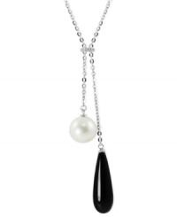 Black and white, and raved all over. This necklace, crafted from sterling silver, features both an onyx (8 mm x 25 mm) and a cultured freshwater pearl (10 mm), along with white topaz accents for a stunning look. Approximate length: 17 inches Approximate drop: 2 inches.