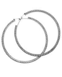 Sparkling and stylish. Large hoop earrings are always a casually chic choice, but GUESS' version goes glam with glittering glass accents. Set in hematite tone mixed metal. Approximate diameter: 2-1/4 inches. Sparkling and stylish. Large hoop earrings are always a casually chic choice, but GUESS' version goes glam with glittering glass accents. Set in hematite tone mixed metal. Approximate diameter: 2-1/4 inches.