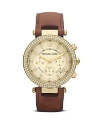 MICAHEL Michael Kors perfects boy-borrowed accessorizing with this classically styled watch. Its leather strap and over-sized face are handsome while a glitzy bezel adds a glamorous hint of femininity. MICAHEL Michael Kors perfects boy-borrowed accessorizing with this classically styled watch. Its leather strap and over-sized face are handsome while a glitzy bezel adds a glamorous hint of femininity.