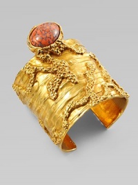 Like a piece of modern sculpture you'd find in a museum, this wide golden cuff combines the intriguing textures of tree bark and rough stone, capped by an oval glass cabochon with a mottled semiprecious look.GlassGoldtoneDiameter, about 2¼Made in Italy Like a piece of modern sculpture you'd find in a museum, this wide golden cuff combines the intriguing textures of tree bark and rough stone, capped by an oval glass cabochon with a mottled semiprecious look.GlassGoldtoneDiameter, about 2¼Made in Italy