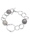 Hammered metal circles of sterling silver shine alongside multicolor iridescent, organic, man-made baroque pearls in this bracelet by Majorica. Approximate length: 7-1/4 inches.