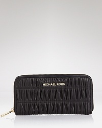 Upgraded yet completely essential, this leather-crafted zip around wallet from MICHAEL Michael Kors keeps it all together with style. Upgraded yet completely essential, this leather-crafted zip around wallet from MICHAEL Michael Kors keeps it all together with style.