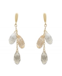 Up your elegance factor in Swarovski's stunning Lagoon earrings. Each pair sparkles elegantly in gold tone mixed metal with Crystal Golden Shadow and clear crystal faceted teardrops. Approximate drop: 2 inches. Up your elegance factor in Swarovski's stunning Lagoon earrings. Each pair sparkles elegantly in gold tone mixed metal with Crystal Golden Shadow and clear crystal faceted teardrops. Approximate drop: 2 inches.