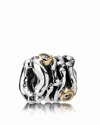 A swirling sterling silver PANDORA charm houses dramatic 14K gold bezel-set diamonds. A swirling sterling silver PANDORA charm houses dramatic 14K gold bezel-set diamonds.