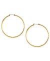 Embellished elegance. Anne Klein adds glass accents to these hoop earrings crafted from gold-tone mixed metal to stunning effect. Approximate diameter: 2 inches.