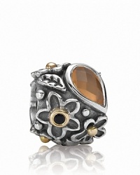 An orange moonstone 'dew drop' stone grounds a sterling silver PANDORA charm with a gold and onyx-accented floral motif. An orange moonstone 'dew drop' stone grounds a sterling silver PANDORA charm with a gold and onyx-accented floral motif.
