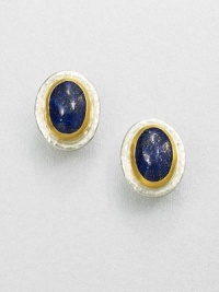 A beautiful, speckled lapis cabochon set in sterling silver and 24k gold. LapisSterling silver24k goldSize, about .9Post backImported 