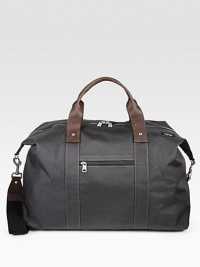 A winged duffle bag constructed in dobby-woven nylon, trimmed with leather and backed with polyurethane for durability and water-resistance. Zip closure Leather handles Removable, detachable shoulder strap Die-cast hardware Exterior slip pocket Interior organization pocket Cotton lining 20½W X 9H X 15D Imported A winged duffle bag constructed in dobby-woven nylon, trimmed with leather and backed with polyurethane for durability and water-resistance. Zip closure Leather handles Removable, detachable shoulder strap Die-cast hardware Exterior slip pocket Interior organization pocket Cotton lining 20½W X 9H X 15D Imported