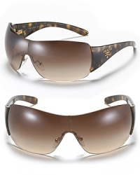Whether it's the snow or the beach, don't forget your Prada shield sunglasses with logo detail at temples. Whether it's the snow or the beach, don't forget your Prada shield sunglasses with logo detail at temples.