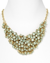 A cluster of mint green stones adorn this gold chain necklace from Aqua. A cluster of mint green stones adorn this gold chain necklace from Aqua.