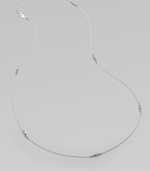 A graceful sterling silver chain, delicately spaced with clusters of tiny, faceted 14k gold beads.14k yellow gold and sterling silverLength, about 26Spring ring claspMade in USA