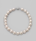 A dramatic yet simple strand of white baroque pearls, with a sparkling clasp of cubic zirconia. 16mm white man-made organic pearls Length, about 17 Sterling silver and cubic zirconia ball clasp Made in Spain