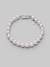 From the Akoya Collection. A simple strand of lustrous white cultured Akoya pearls with a signature filigree clasp. 7mm white, round cultured pearls Quality: A1 18k white gold Length, about 7 Mikimoto signature clasp Imported