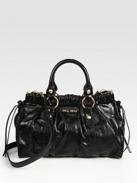 Luxe vitello calfskin, gathered at the top and laced at sides in a cinched top-handle carryall.Double top handles, 4½ dropDetachable shoulder strap, 20¾ dropTop snap closureMetal letter logo detailProtective metal feetOne inside zip pocketOne inside open pocketCotton/satin lining13¼W X 9H X 4¾DMade in Italy Luxe vitello calfskin, gathered at the top and laced at sides in a cinched top-handle carryall.Double top handles, 4½ dropDetachable shoulder strap, 20¾ dropTop snap closureMetal letter logo detailProtective metal feetOne inside zip pocketOne inside open pocketCotton/satin lining13¼W X 9H X 4¾DMade in Italy