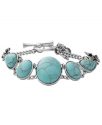 Breezy, bohemian style. Perfect for the free spirit, Fossil's trendy toggle bracelet includes reconstituted turquoise stones set in vintage silver tone mixed metal bezels with orchid details. Approximate length: 8 inches. Breezy, bohemian style. Perfect for the free spirit, Fossil's trendy toggle bracelet includes reconstituted turquoise stones set in vintage silver tone mixed metal bezels with orchid details. Approximate length: 8 inches.