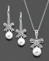 Dazzling bows with diamond accents are the perfect accompaniment to smooth cultured freshwater pearls (6-7.5 mm) on this matching pendant and earrings set in sterling silver. Pendant measures approximately 18 inches with a 1-inch drop. Earrings measure approximately 1 inch. Dazzling bows with diamond accents are the perfect accompaniment to smooth cultured freshwater pearls (6-7.5 mm) on this matching pendant and earrings set in sterling silver. Pendant measures approximately 18 inches with a 1-inch drop. Earrings measure approximately 1 inch.