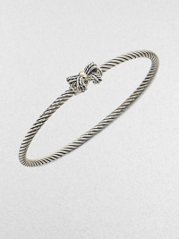 A charming, sterling silver cable design with a radiant 18k gold accented bow. Sterling silver18k goldDiameter, about 2½Slip-on styleImported 