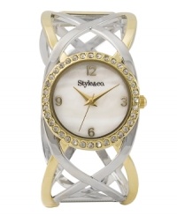 Lock in a unique look with this open work bangle watch by Style&co. Two tone mixed metal open work bangle bracelet and round case. Bezel embellished with crystal accents. Mother-of-pearl dial features gold tone numerals at twelve, three, six and nine o'clock, three hands and logo. Quartz movement. Two-year limited warranty. Lock in a unique look with this open work bangle watch by Style&co. Two tone mixed metal open work bangle bracelet and round case. Bezel embellished with crystal accents. Mother-of-pearl dial features gold tone numerals at twelve, three, six and nine o'clock, three hands and logo. Quartz movement. Two-year limited warranty.