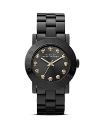 Substance meets MARC BY MARC JACOBS style on this plated metal watch which is illuminated by bright crystals, an engraved logo, and a smooth round dial. Substance meets MARC BY MARC JACOBS style on this plated metal watch which is illuminated by bright crystals, an engraved logo, and a smooth round dial.