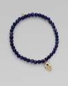 The open hand or hamsa, a symbol of protection to many cultures, is depicted in diamonds set in 14k yellow gold with a sapphire center, and hangs on a strand of deeply hued sodalite beads. Diamonds, 0.04 tcw Sapphire Sodalite 14k yellow gold Diameter, about 2 Charm length, about ½ Stretch cord Imported